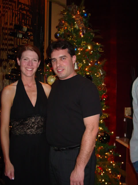 Tim and Jill in front of the Christmas tree at Jiko